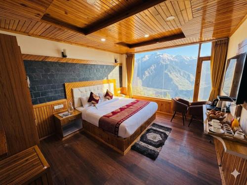 a bedroom with a bed and a large window at The Hamilton Valley View, Koti - A Beautiful Resort in Cloud's in Shimla