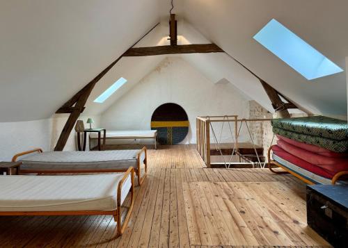 a room with two beds in a attic at Authentic house, absolutely quiet in Coust