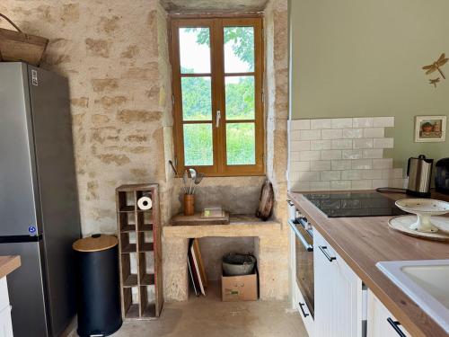 a kitchen with a sink and a window at Authentic house, absolutely quiet in Coust