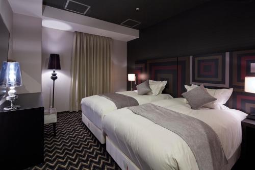 Ένα ή περισσότερα κρεβάτια σε δωμάτιο στο Centurion Hotel Grand Kobe Station