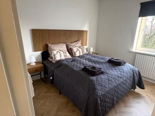 a bedroom with a large bed and a window at Ama Hyg Atelier Copenhagen-Delicius apartment near the Beach,Metro, Airport in Copenhagen