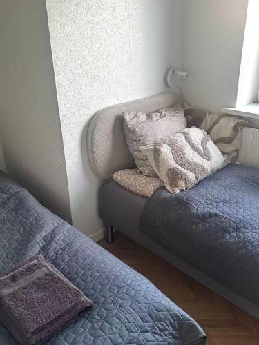 a bedroom with two beds and a window at Ama Hyg Atelier Copenhagen-Delicius apartment near the Beach,Metro, Airport in Copenhagen