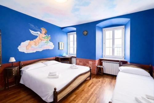 a bedroom with two beds and a painting on the wall at Hotel Portacavana in Trieste