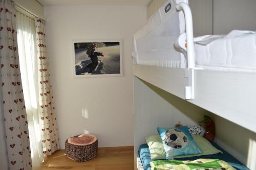 a childs room with a bunk bed and a staircase at Ferienwohnung Caluna in Lenz