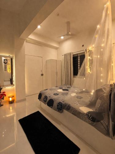 a bedroom with a bed with lights on it at LaBelle Haven Aesthetic Cozy 2BHK For Family and Couples in Indore