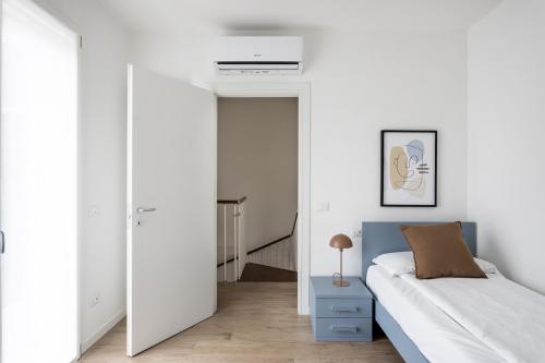 a bedroom with a bed and a blue nightstand at Maison Bellini 1 in Toscolano Maderno