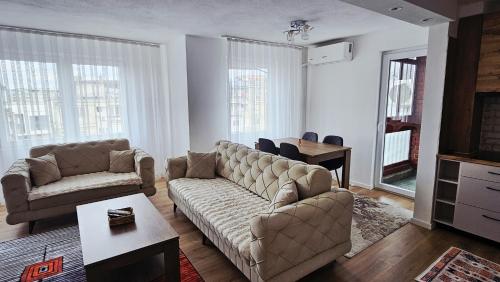 a living room with a couch and a table at HTH Apartments in Center of Gjakova - 4th Floor in Gjakove