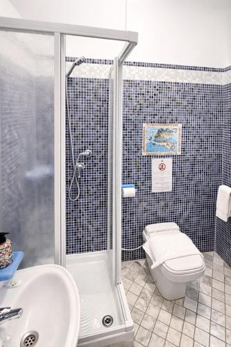 a bathroom with a shower and a toilet and a sink at Hotel Portacavana in Trieste