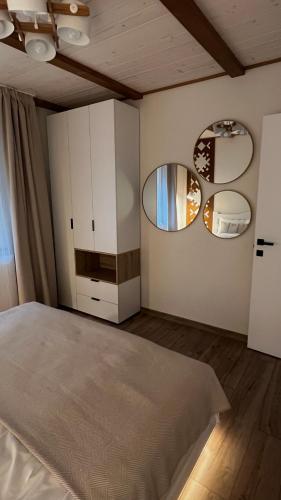 a bedroom with a bed and two mirrors at Gonta house in Skhidnitsa