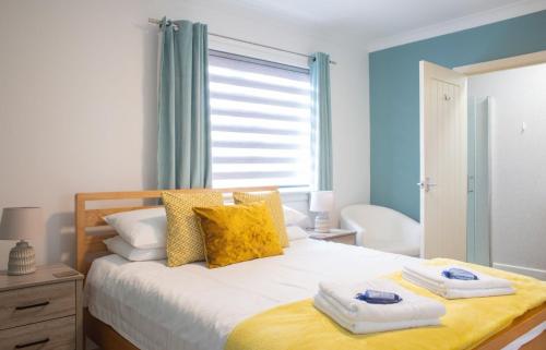a bedroom with a large bed with towels on it at Skeabost View Chalet in Portree