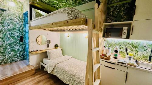 a small room with a bunk bed and a desk at RB Portobello in London