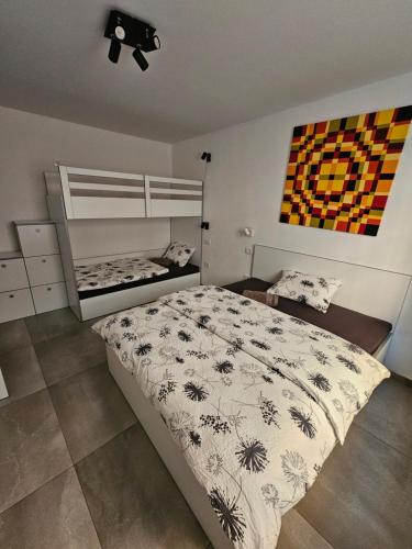 a bedroom with a bed and a bunk bed at Mark & Lana in Sežana