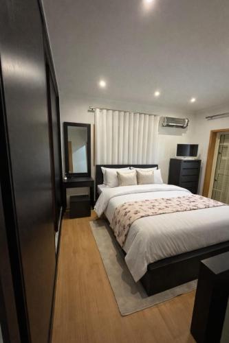a bedroom with a large bed and a window at Casa Encosta do Marao in Amarante
