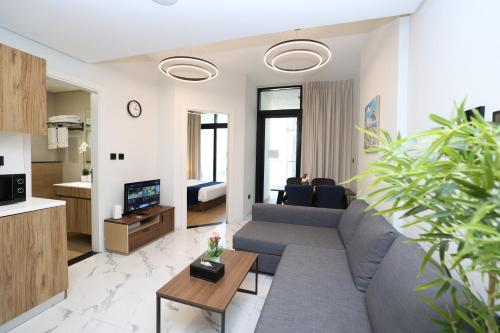 a living room with a couch and a table at 1 Bedroom in Maryah Island by Central Stay 1 min to Cleveland, Galleria Mall and ADGM in Abu Dhabi