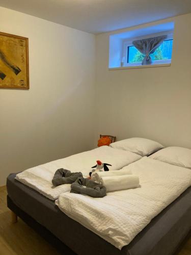 a bed with a stuffed animal sitting on top of it at Le Charme de Colmar B&B in Colmar
