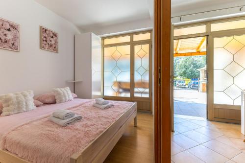 a bedroom with a bed with two towels on it at Milankovic Apartments in Vrsar