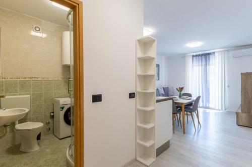 a bathroom with a toilet and a sink in a room at Milankovic Apartments in Vrsar