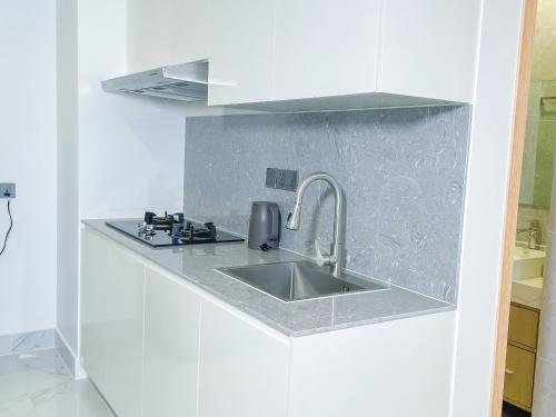 a kitchen with a sink in a white kitchen at TV-Tower 1 in Phnom Penh
