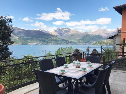 a table on a balcony with a view of a lake at Castelaus, Lake view, 1 Min Walk from the Lake in Dervio