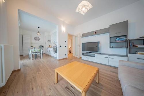 a living room with a table and a couch at Castelaus, Lake view, 1 Min Walk from the Lake in Dervio