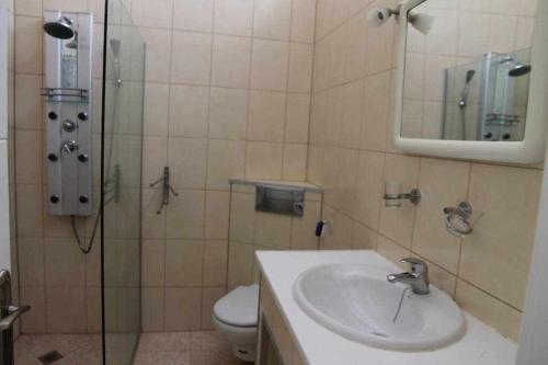 a bathroom with a sink and a toilet and a mirror at Estupendo bungalow cerca del mar in Maspalomas