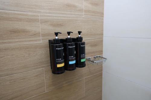 a group of three bottles sitting on a tile wall at 1 Bedroom in Maryah Island by Central Stay 1 min to Cleveland, Galleria Mall and ADGM in Abu Dhabi
