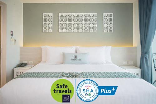 a bed with a sale travels sign next to it at Peranakan Boutique Hotel - SHA Plus in Phuket