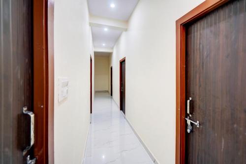an empty corridor with a door at Hotel O Hotel Denmark in Chinhat