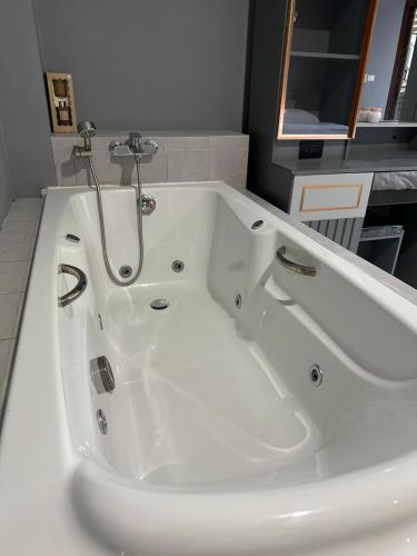 a large white bath tub in a bathroom at Vera House in North Pattaya