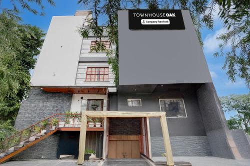 a house with a sign in front of it at Super Townhouse Oak Arvindo Park Indira Nagar Formerly Rama Inn in Vibhuti Khand