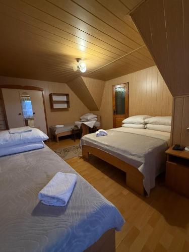 a large room with two beds in a room at Kwatery u Papieżów in Biały Dunajec