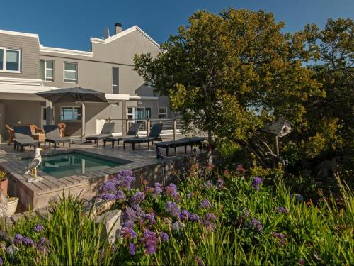 a backyard with a swimming pool and a house at Absolute Ocean Boutique Guesthouse in Hermanus