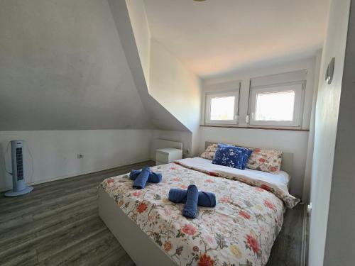 a bedroom with a bed with two blue towels on it at Apartman Gloria Sajam - Panorama in Belgrade