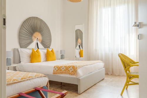 a bedroom with two beds and a mirror on the wall at L'Acqua e la Pietra in Rapolano Terme