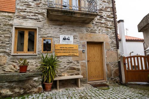 a stone building with a door and a balcony at Casa do Lagar in Vale do Porco