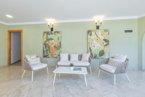 a living room with two chairs and a table at BLUESEA Miramar Fuengirola in Fuengirola