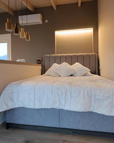 a bedroom with a bed with a mirror on the wall at VueSurMer Amarynthos in Amarynthos