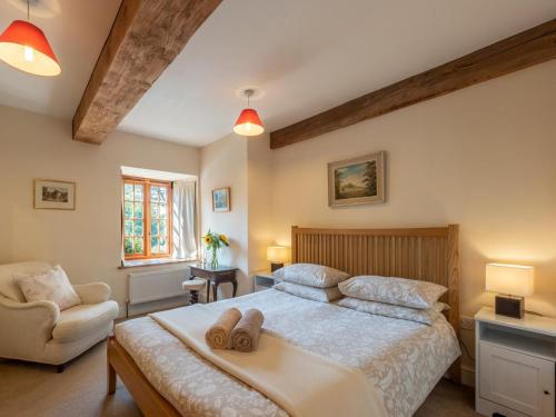 a bedroom with a bed with two slippers on it at 8 Bed in Llanigon oc-bn241 in Llanigon