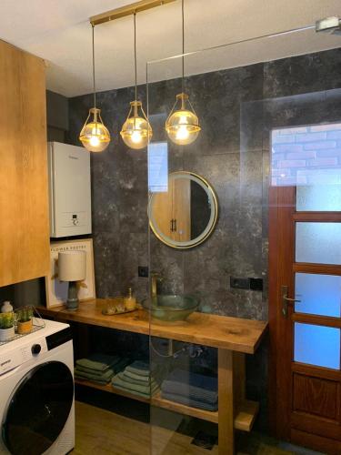 a kitchen with a table and some lights at Sokograd Entire House in Šipovo