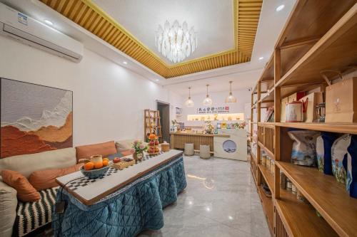 a living room with a couch and a table at JINGJING·YUNXI·WEITANG HOTEL in Zhangjiajie