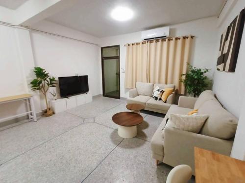 a living room with a couch and a tv at D72 Family House, 8PAX 3BR Hat Yai Middle Town in Hat Yai