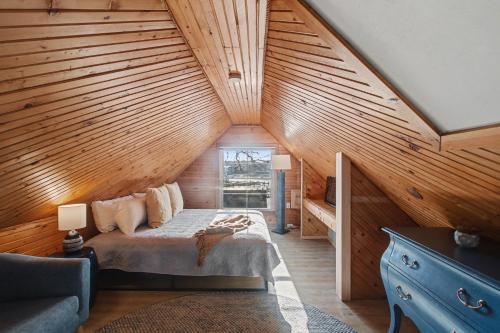 a bedroom with a bed in a wooden attic at Waters View Inn in South Haven