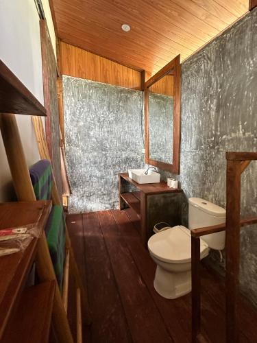 a bathroom with a toilet and a sink at Panoramic Samplik View Sidemen in Silebeng