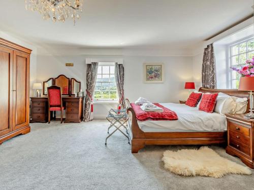 a bedroom with a bed and a desk and a window at 5 Bed in Machynlleth oc-92513 in Machynlleth
