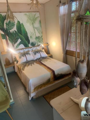 a bedroom with a swing bed in a room at The Palms Ocean views in Rodrigues Island