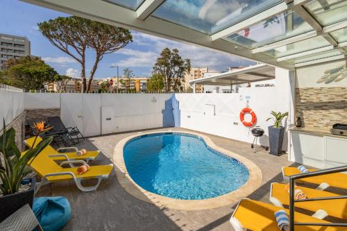 a swimming pool on the roof of a building at Centralgarve - Villa Crown 22 in Quarteira