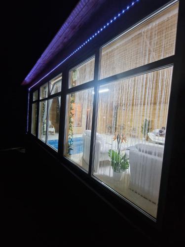 a room with a window with a view of a patio at Casutele Anei- Aframe&Spa in Rişca