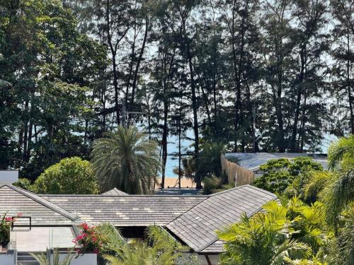 a view of a house with trees in the background at Pearl of Naithon beach 4 Bedrooms in Phuket