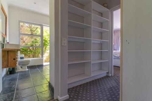 a walk in closet with white shelves in a room at Silvermist Organic Wine Estate in Cape Town