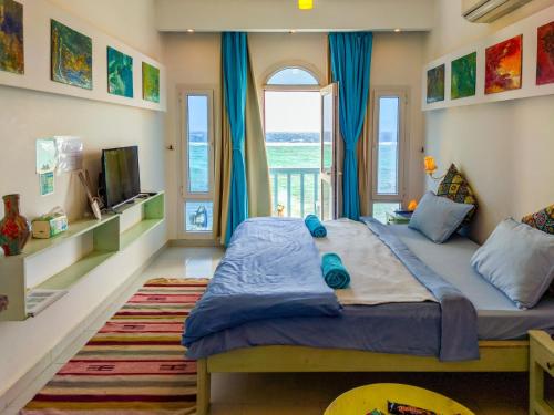 a bedroom with a large bed with a window at Skyrock Dahab in Dahab